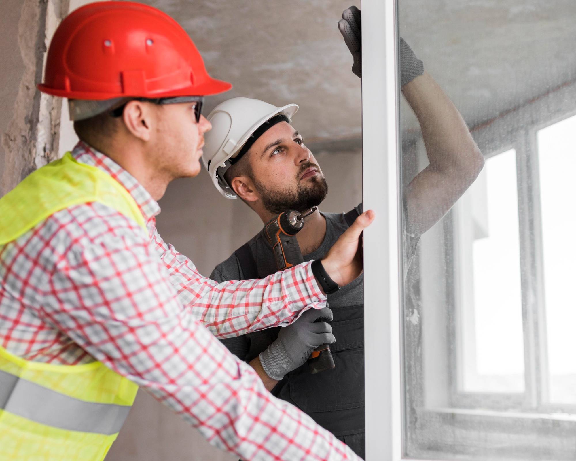 Construction workers installing replacement window, Creative Home Improvement LLC services in Milford Connecticut.