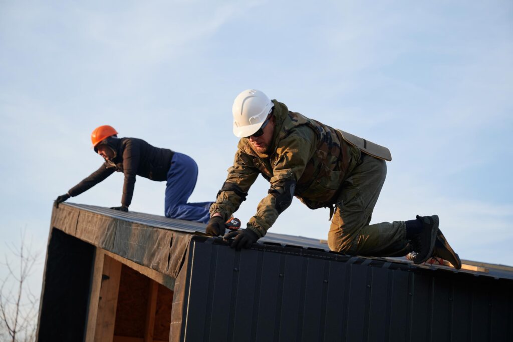 builder-installing-corrugated-iron-sheet-used-as-f-2022-08-19-07-46-25-utc.jpg