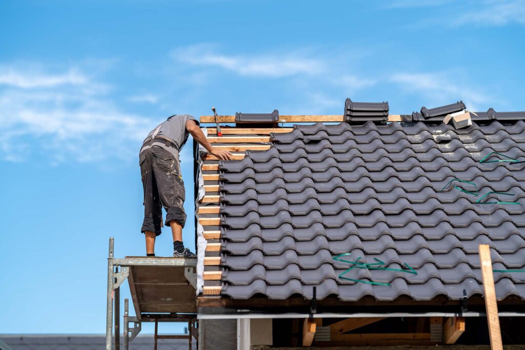 builder-on-the-roof-of-a-family-house-building-a-2023-09-09-04-36-44-utc.jpg